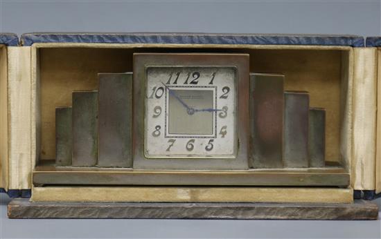 An Art Deco silvered bronze mantel timepiece with fitted case, retailed by Roman Mayer, Lausanne and Montreux